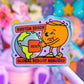 A colorful cartoon sticker or pin featuring an orange character winking while holding a globe, with text reading 'SYSTEM ERROR' and 'GLOBAL REBOOT REQUIRED', shown against a soft blurred pastel background.